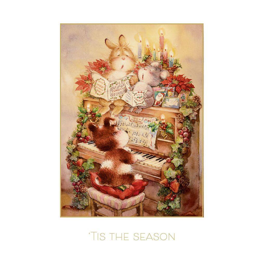 Pictura Christmas card featuring a playful puppy dog sitting at a piano with holiday decorations and festive Christmas themes.